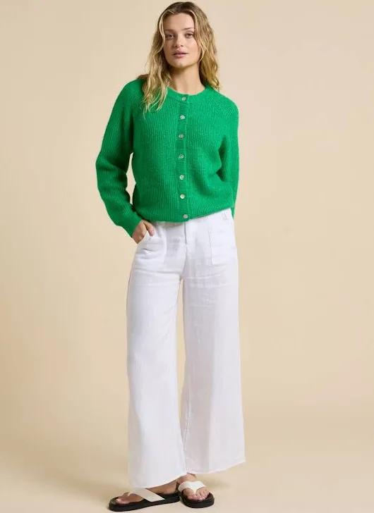 Add a pop of colour and effortless charm to your wardrobe.

The Olivia Cardigan by Little Lies is crafted in a fresh, vibrant green. This timeless knit is your go-to for easy layering and all-day comfort. Its slightly oversized fit makes it perfect over tees, dresses, or even another lightweight layer, giving you that relaxed, stylish vibe without trying too hard. The button-front closure, adorned with delicate shell buttons, adds a subtle touch of natural elegance to a classic silhouette.