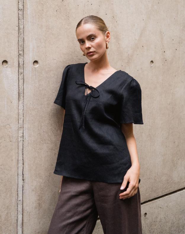 Chic, Effortless, and Ready to Wear

Meet the Delight Top – Black by White Closet, your go-to for laid-back elegance with a modern twist. Crafted from breathable linen, this top keeps you cool and comfy while looking effortlessly polished. The floaty sleeves and relaxed silhouette create an easy, airy vibe, while the front tie-up detail adds a subtle, feminine touch that’s perfectly sophisticated.