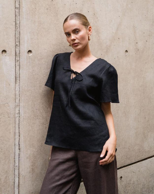 Chic, Effortless, and Ready to Wear

Meet the Delight Top – Black by White Closet, your go-to for laid-back elegance with a modern twist. Crafted from breathable linen, this top keeps you cool and comfy while looking effortlessly polished. The floaty sleeves and relaxed silhouette create an easy, airy vibe, while the front tie-up detail adds a subtle, feminine touch that’s perfectly sophisticated.