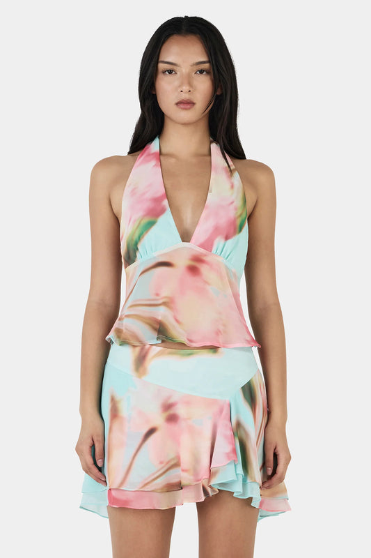 The Yiana Mini Skirt is a bias cut mini skirt with a layered, flowy design and an asymmetrical hem. The skirt is fully lined and pairs perfectly with the Lolita Top for a complete set.