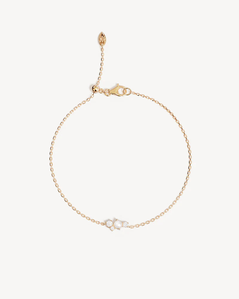 The Love in Stillness Pearl Bracelet celebrate those unseen moments - when we close our eyes to feel deeper, to connect beyond sight with love, with memory, with presence. This keepsake is an expression of romance in its softness and stillness.&nbsp;

18k Gold Vermeil: 2.5 microns of 18 carat gold coating a sterling silver base.&nbsp;

Delicate pearl cluster design.&nbsp;

Set with a round freshwater pearl and cubic zirconias in a claw setting.&nbsp;

Bracelet length: 19cm.&nbsp;

Features a silicon ball sl