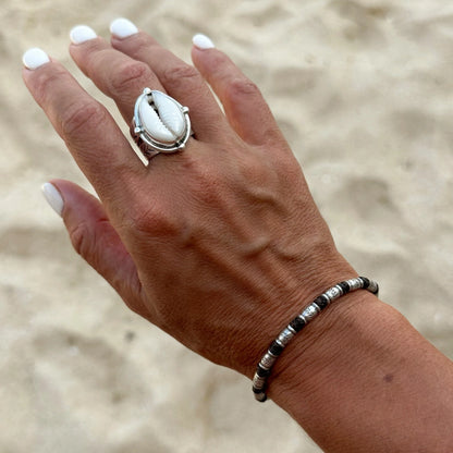 Discover the Bamboo Sea Bracelet, meticulously handcrafted with Hill Tribe Silver and adorned with a polywax cotton band. Symbolising growth and harmony with nature, this bracelet's organic texture and vibrant colours serve as a daily reminder of your connection to the natural world. Experience boho-inspired elegance with Embella's Bamboo Bracelet.