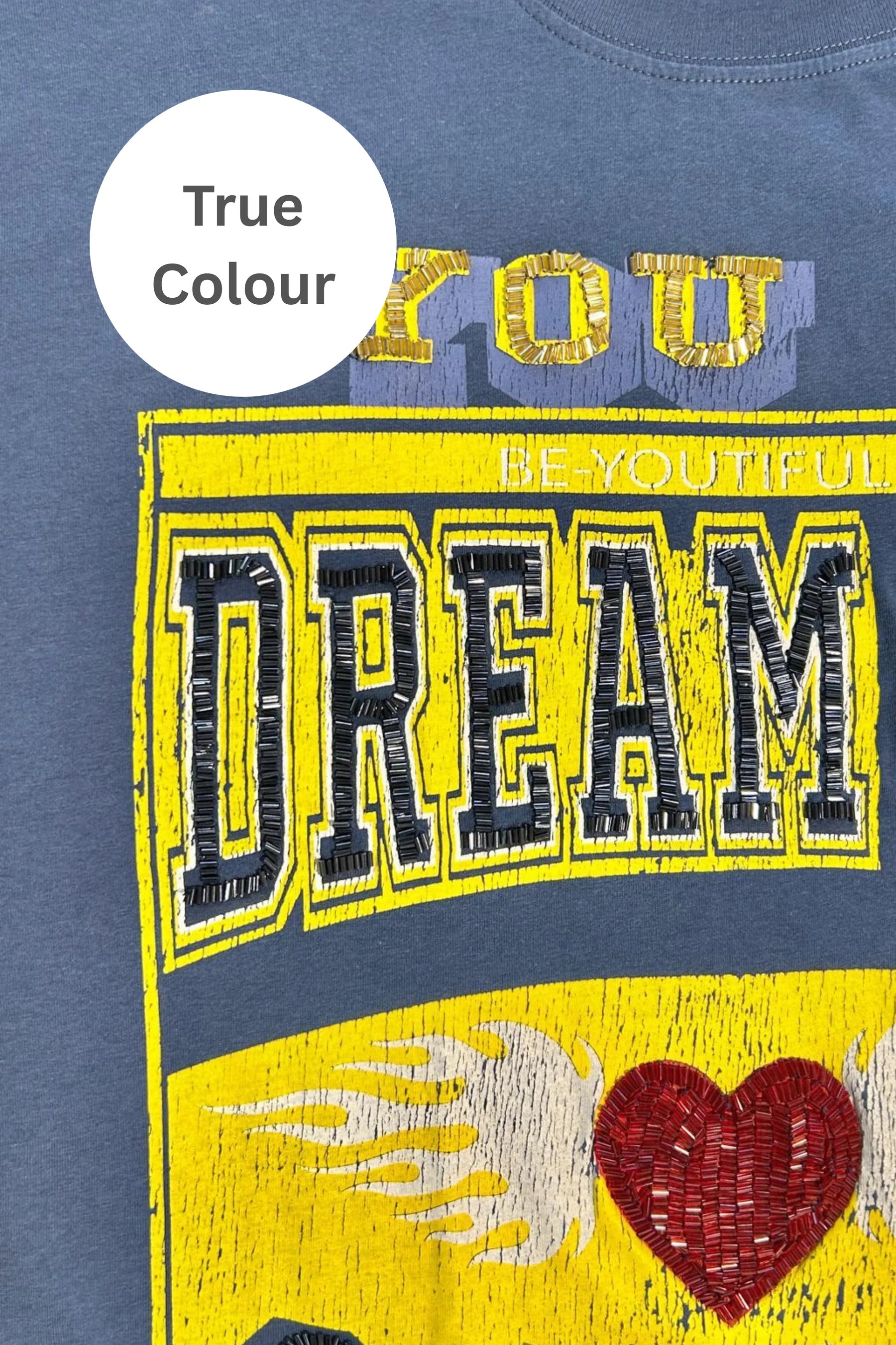 Go big, dream louder. This tee’s not here to play small.

Big vibes, bold energy. The Very Oversized Dream Big Beaded Tee by Sabbi is made for those who dream loud, live freely, and never wait for permission. With our signature very oversized silhouette, it’s all about effortless comfort, relaxed proportions, and graphics that stand out.

The varsity-inspired Dream Big Sabbi front print pops with beaded detailing, while the striking Be Fearless 71 statement on the back channels vintage sports energy with a 