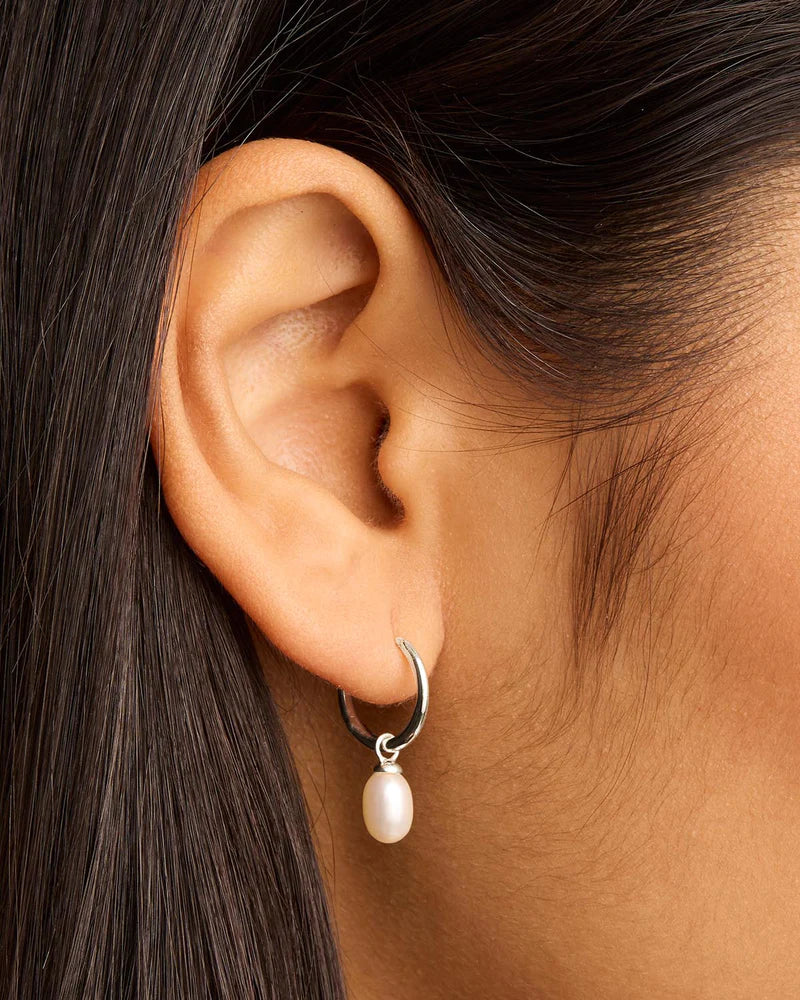 Find inner peace, balance and tranquillity with our&nbsp;Silver&nbsp;Live in Peace Hoops. This elevated take on the classic pearl earring is designed to inspire optimism and stillness, even amidst chaos.