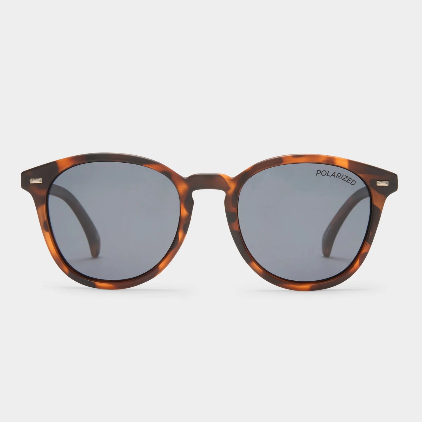 With vintage inspired details, our iconic BANDWAGON frame is the perfect all-round sunglass offering a timeless aesthetic. Featuring a keyhole nose bridge and refined angles, this midsize style is finished with discreet metal rivet detailing and Le Specs flagstripe metal hardware.

• Finished in a matte tort frame paired with dark smoke mono lenses.
• A lightweight, durable and impact resistant polycarbonate frame.
• Fitted with polarized lenses to eliminate unwanted reflective glare.