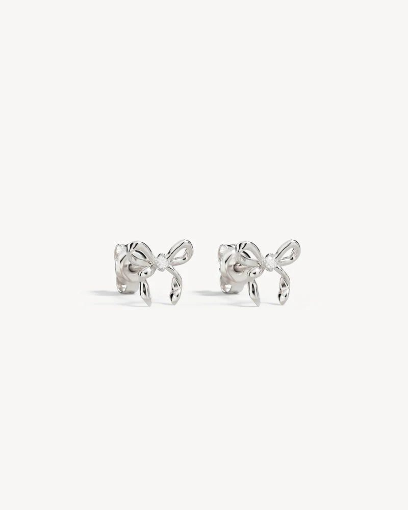 By Charlotte - The Forever More Bow Stud Earrings are a playful and delicate ode to love and romance. This keepsake is a tangible expression of the saying "tied together", with the bows symbolising love, cherished bonds, and devotion.&nbsp;

Sterling Silver: 92.5% pure silver and 7.5% alloy.&nbsp;

Delicate bow design set with a sparkling cubic zirconia.&nbsp;

Sold as a pair.&nbsp;

9 x 8mm.&nbsp;

Polished finish.&nbsp;