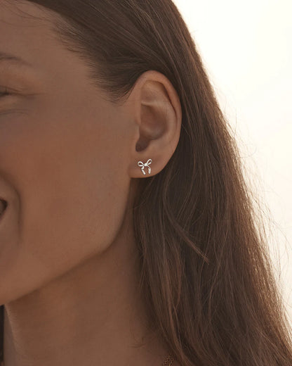 By Charlotte - The Forever More Bow Stud Earrings are a playful and delicate ode to love and romance. This keepsake is a tangible expression of the saying "tied together", with the bows symbolising love, cherished bonds, and devotion.&nbsp;

Sterling Silver: 92.5% pure silver and 7.5% alloy.&nbsp;

Delicate bow design set with a sparkling cubic zirconia.&nbsp;

Sold as a pair.&nbsp;

9 x 8mm.&nbsp;

Polished finish.&nbsp;