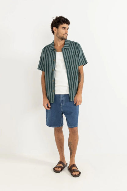 The Eli Stripe SS Shirt in Teal offers classic design with a modern twist. Featuring a one-piece collar, button-front closure, and a chest pocket, this shirt’s straight hem makes it an easy-wearing staple for warmer days.