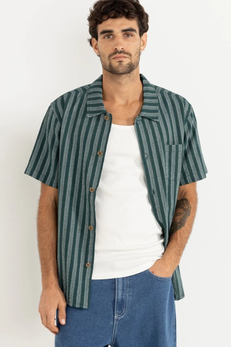 The Eli Stripe SS Shirt in Teal offers classic design with a modern twist. Featuring a one-piece collar, button-front closure, and a chest pocket, this shirt’s straight hem makes it an easy-wearing staple for warmer days.