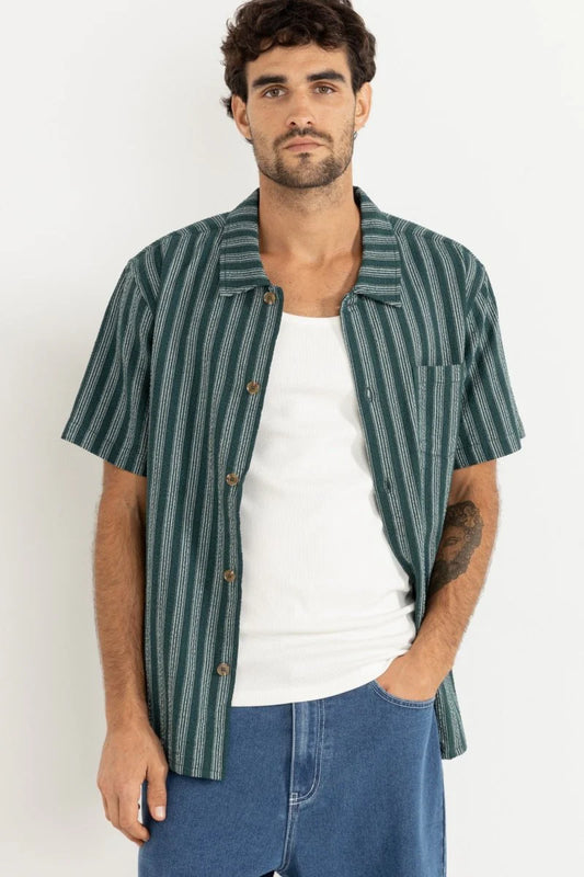 The Eli Stripe SS Shirt in Teal offers classic design with a modern twist. Featuring a one-piece collar, button-front closure, and a chest pocket, this shirt’s straight hem makes it an easy-wearing staple for warmer days.