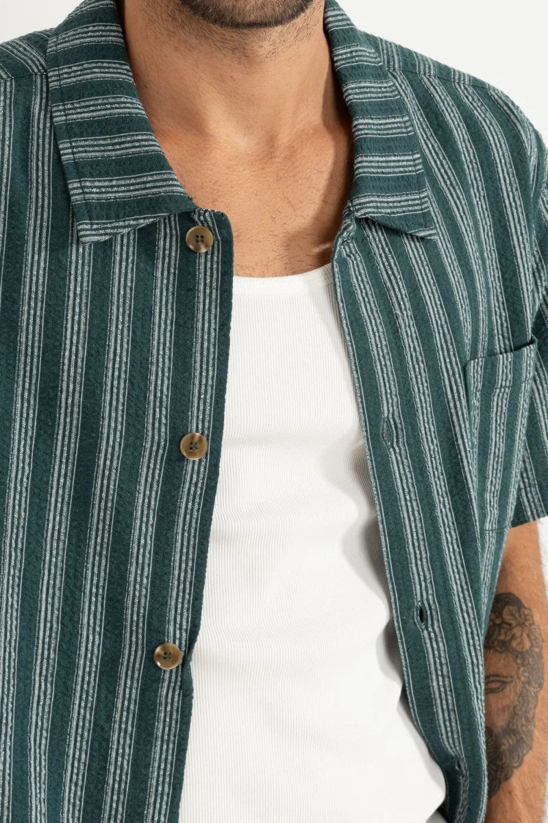 The Eli Stripe SS Shirt in Teal offers classic design with a modern twist. Featuring a one-piece collar, button-front closure, and a chest pocket, this shirt’s straight hem makes it an easy-wearing staple for warmer days.