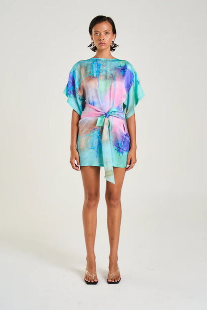 Your new “throw it on and instantly look styled” moment just dropped.

The Summi Summi Tie Front Dress – H20 Print brings wearable art into everyday dressing, featuring a hand-painted-inspired design that feels fresh, expressive, and effortlessly cool. It’s the kind of mini that turns heads quietly, no loud effort needed.