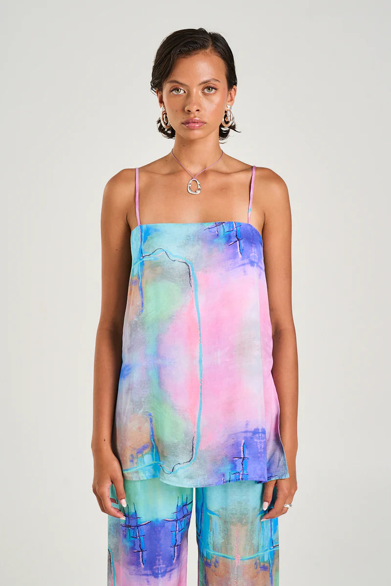 Breezy, Artsy, and Effortlessly Chic

Step into effortless style with the Summi Summi Tunic Top – H20, your new go-to for relaxed, warm-weather vibes. Crafted from a luxuriously soft viscose-rayon blend, this tunic drapes beautifully, moving with you for all-day comfort. The straight-cut bodice and adjustable straps let you tailor the fit, while playful side slits add a hint of movement and fun with every step. Whether layered over your favourite shorts or worn on its own, it’s a versatile piece that’s equa