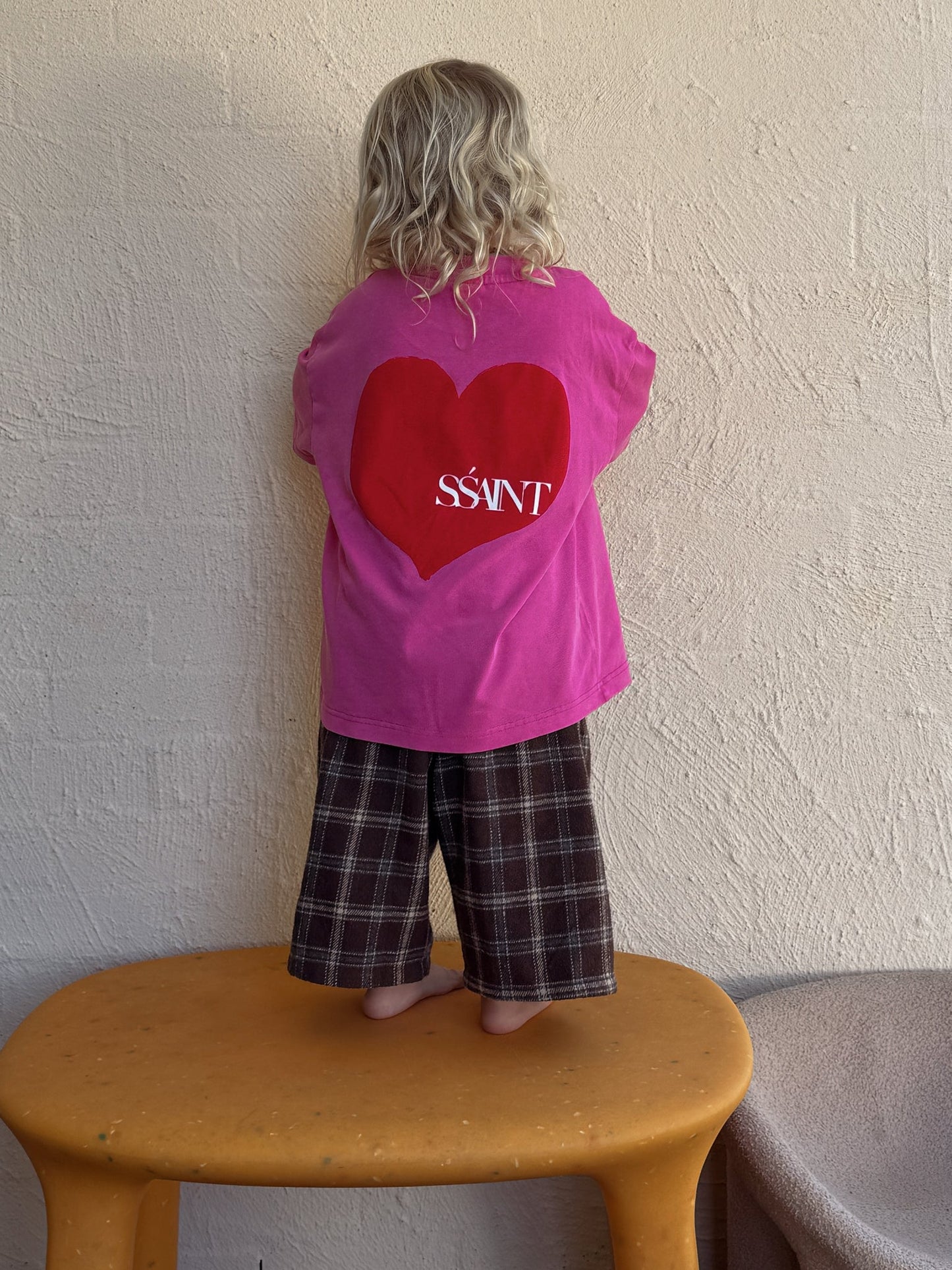 Introducing the Kids' Heart Tee in Acid Wash Pink

A little heart on the front, a whole lot of love on the back. This SSaint unisex tee is perfect for the little lovers of the world. Made from 100% cotton with a relaxed fit, it’s designed for effortless comfort and style. Match with your mini and pair it back with our SŚAINT No Vacancy Tee for a coordinated look.