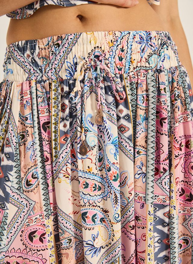 Step into effortless elegance with the Malina Maxi Skirt. Crafted from a luxe 100% viscose fabrication with subtle gold lurex stripe detailing, it features a comfortable shirred waistband and a self-tie finished with gold bead accents. A timeless addition to your wardrobe, this piece makes a refined yet striking impression.

Product Details:

Soft, Breathable Mesh Fabrication
Lurex stripe detail
Shirred Waistband With metal bead  Finish
Maxi length
