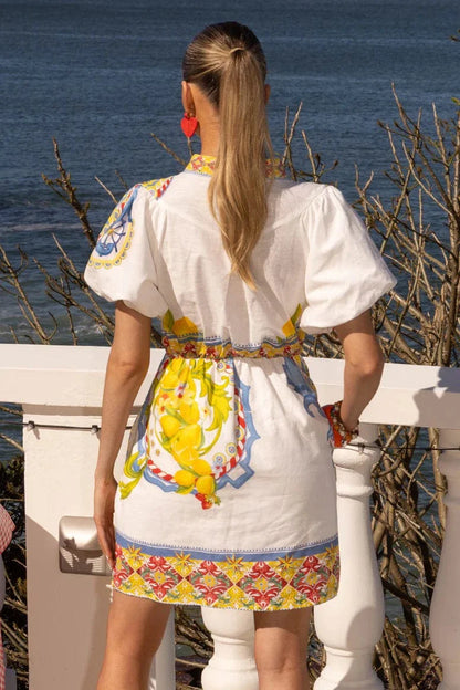 Your Euro summer moment. Wrapped up in one dreamy little dress.

Meet the Mia Milani White Coast Dress, a fresh, feminine mini that captures the magic of sun-drenched days and coastal getaways. Designed in crisp white with vibrant Mediterranean-inspired prints, it’s the kind of piece that instantly transports you to long lunches by the sea.