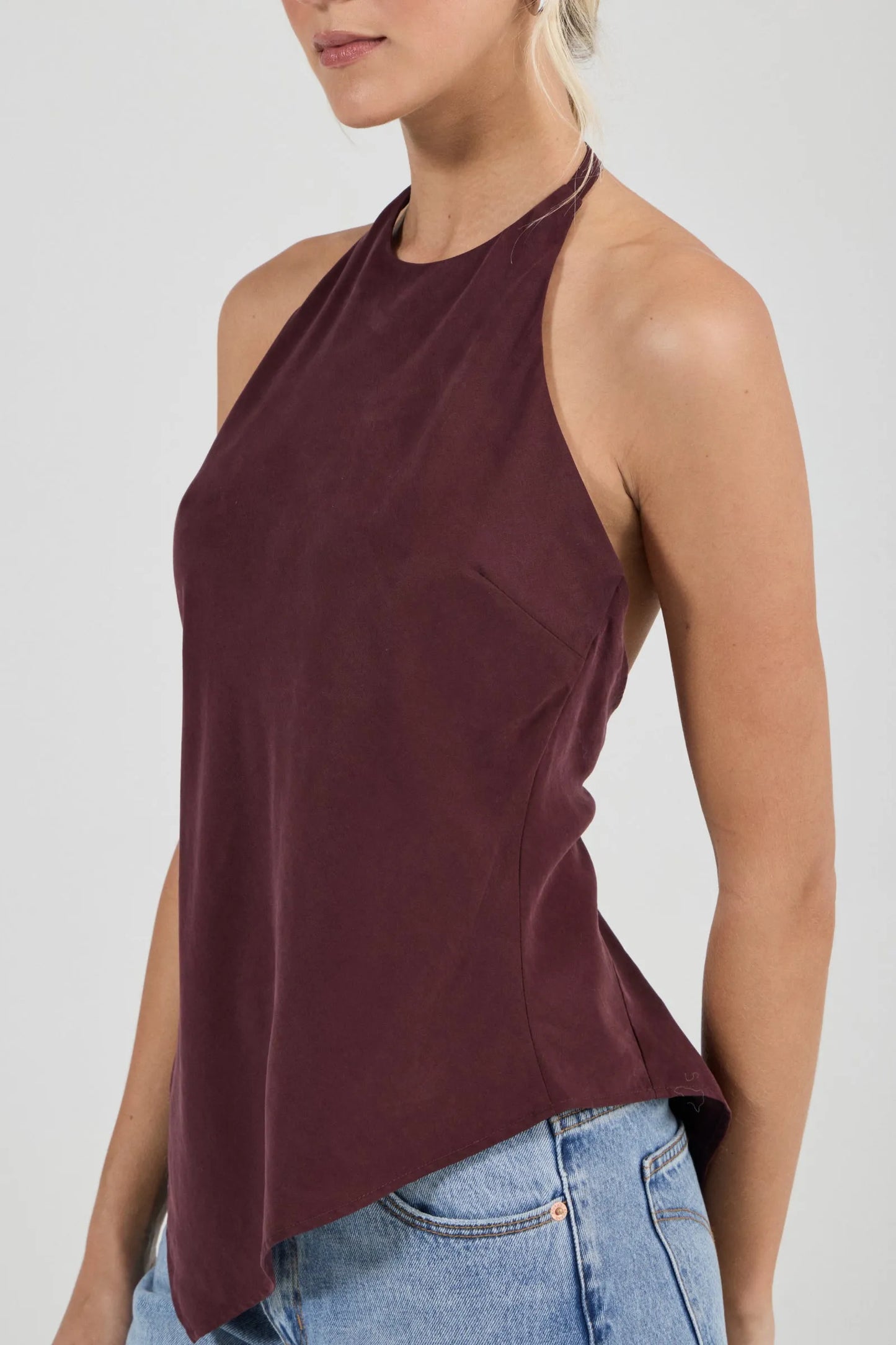 Sleek halter top crafted with a flattering bias cut to skim the body
Features a high neckline and a striking asymmetrical hem
Modern design inspired by 90s minimalism
Designed for effortless, elevated styling
Perfect for pairing with vintage-inspired denim for a night out
Made with 100% Acetate