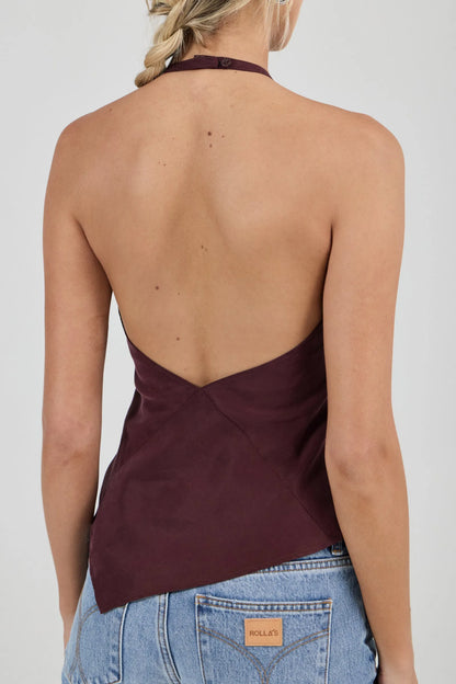 Sleek halter top crafted with a flattering bias cut to skim the body
Features a high neckline and a striking asymmetrical hem
Modern design inspired by 90s minimalism
Designed for effortless, elevated styling
Perfect for pairing with vintage-inspired denim for a night out
Made with 100% Acetate