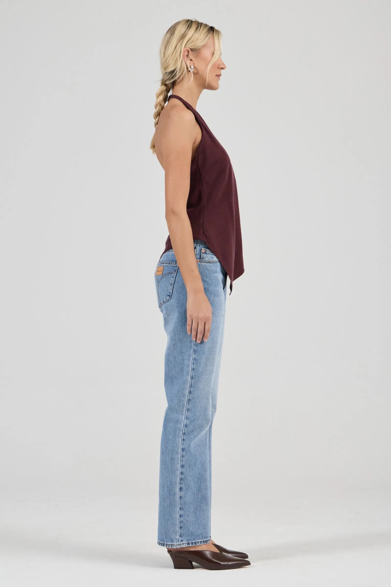 Sleek halter top crafted with a flattering bias cut to skim the body
Features a high neckline and a striking asymmetrical hem
Modern design inspired by 90s minimalism
Designed for effortless, elevated styling
Perfect for pairing with vintage-inspired denim for a night out
Made with 100% Acetate