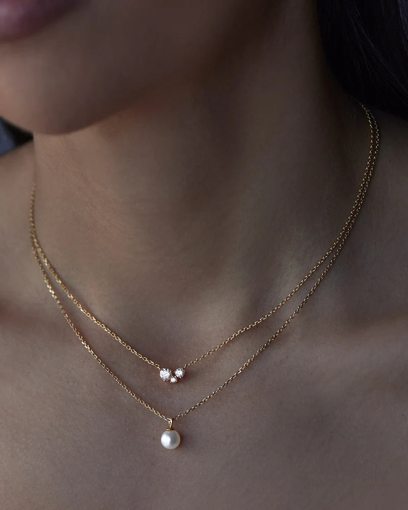 The&nbsp;Whispers of Love Necklace&nbsp;features a classic trio design with an asymmetrical twist&nbsp;with&nbsp;varying sizes of round-cut crystals.&nbsp;This piece is a&nbsp;visual poem to the simplicity of love - and all the quiet magic it holds.&nbsp;It’s&nbsp;classic and delicate design&nbsp;is the perfect subtle touch of sparkle for the&nbsp;bride&nbsp;looking to shine in her own light.&nbsp;