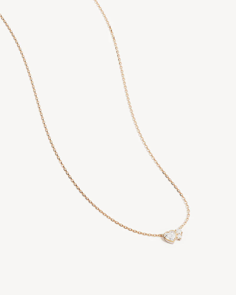 By Charlotte - The Dream Lover Heart Necklace speaks to the unspoken connections and the in-between moments of utmost intimacy. The delicate heart cluster design encapsulates the dreamy moments of tender love and connections we hold closest to our hearts.&nbsp;

18k Gold Vermeil: 2.5 microns of 18 carat gold coating a sterling silver base.&nbsp;

Necklace length: 18 inches (45.72cm).&nbsp;

Features a silicon ball slider to customise length.&nbsp;

Pendant: 9 x 6mm.&nbsp;

Set with heart and round cut cubic