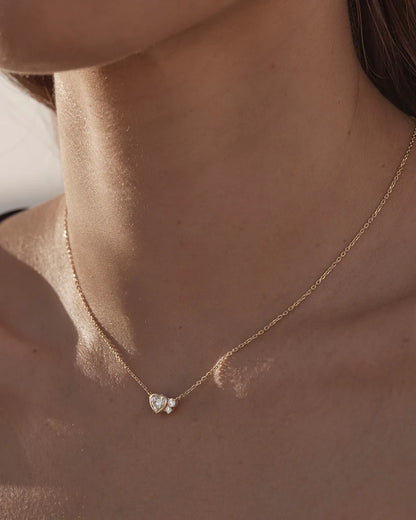 By Charlotte - The Dream Lover Heart Necklace speaks to the unspoken connections and the in-between moments of utmost intimacy. The delicate heart cluster design encapsulates the dreamy moments of tender love and connections we hold closest to our hearts.&nbsp;

18k Gold Vermeil: 2.5 microns of 18 carat gold coating a sterling silver base.&nbsp;

Necklace length: 18 inches (45.72cm).&nbsp;

Features a silicon ball slider to customise length.&nbsp;

Pendant: 9 x 6mm.&nbsp;

Set with heart and round cut cubic