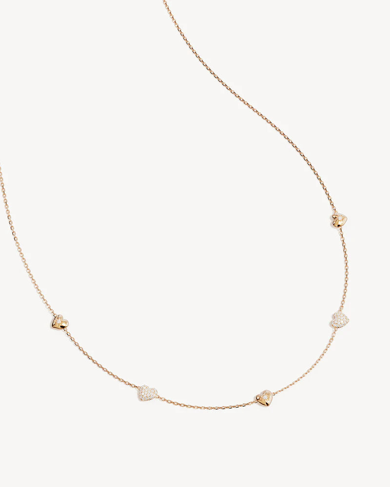 By Charlotte -&nbsp;The You Have My Heart Charm Choker is a joyful and sparkling proclamation of love and connection, re-imagining the heart motif into a playful charm design featuring alternating crystal encrusted pendants. Wear this design as a reminder of the love that surrounds, enriches, and strengthens you every day. &nbsp;

18k Gold Vermeil: 2.5 microns of 18 carat gold coating a sterling silver base.&nbsp;

Hearts are puffy and asymmetrical.&nbsp;
