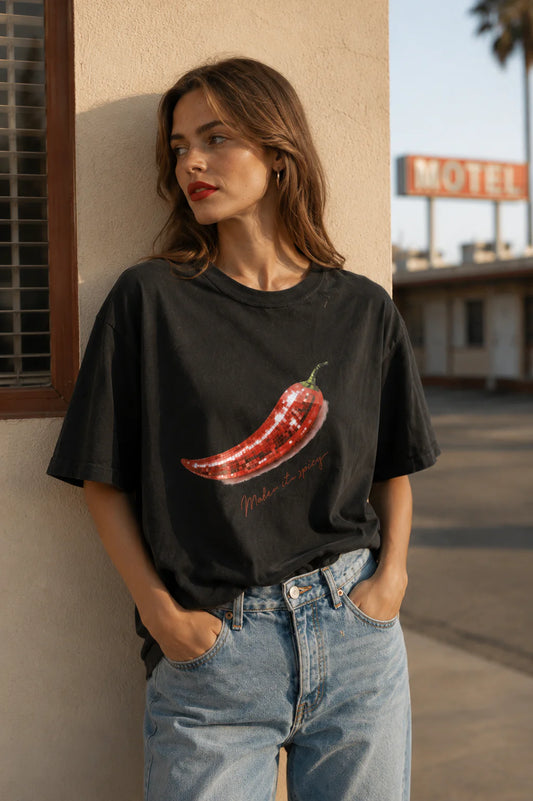 The Make It Spicy Tee is your throw-on-and-go statement piece — featuring an oversized relaxed fit and playful chilli graphic with a subtle retro feel. Crafted from soft 100% cotton in a washed black finish, it’s the kind of tee that looks even better styled back with lived-in denim, relaxed tailoring or cut-off shorts.

Designed with an effortless boyfriend-inspired silhouette, this tee is perfect half-tucked, layered or worn oversized for that undone cool-girl feel.

100% Cotton
Oversized relaxed fit
Vint