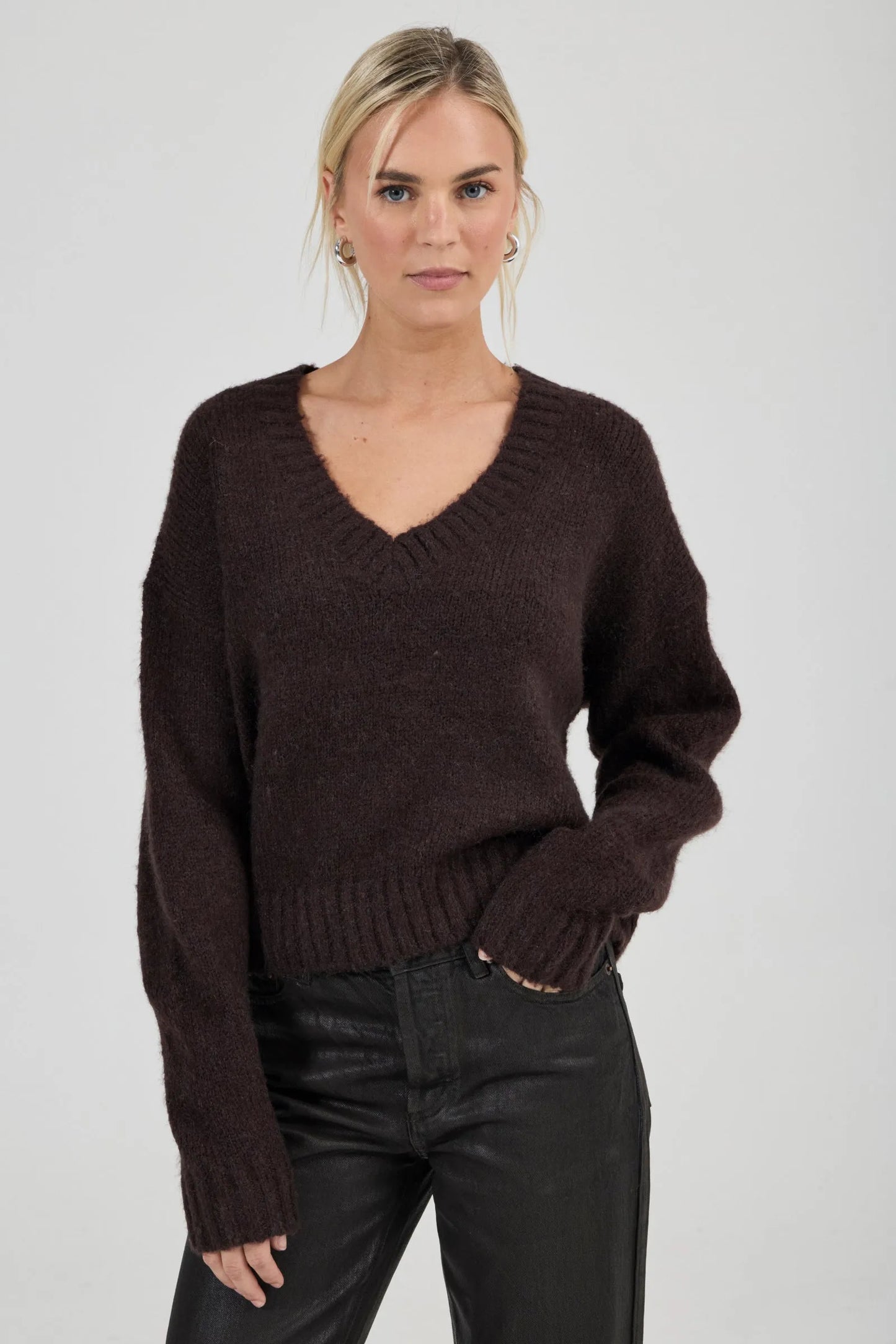 Effortlessly relaxed sweater with a slouchy, slightly oversized fit
Crafted from a luxuriously soft, brushed yarn blend with a touch of wool
Features a flattering deep V-neckline and dropped shoulders for comfort
Finished with chunky ribbed trims at the collar, cuffs, and hem
Rich espresso knit designed as an ideal layering piece
Provides a lived-in, effortlessly cool finish to your everyday look