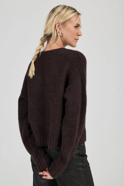 Effortlessly relaxed sweater with a slouchy, slightly oversized fit
Crafted from a luxuriously soft, brushed yarn blend with a touch of wool
Features a flattering deep V-neckline and dropped shoulders for comfort
Finished with chunky ribbed trims at the collar, cuffs, and hem
Rich espresso knit designed as an ideal layering piece
Provides a lived-in, effortlessly cool finish to your everyday look